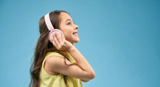 happy-little-girl-with-long-hair-in-pink-headphones-smiling
